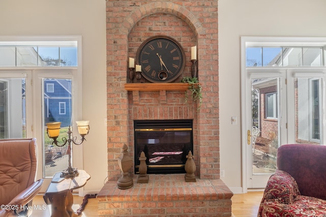 living area with a fireplace and wood finished floors