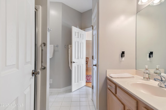 bathroom featuring tile patterned flooring, vanity, and baseboards