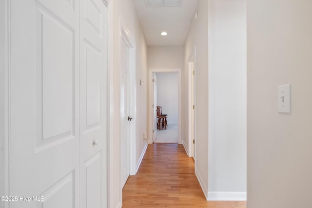 corridor featuring recessed lighting, visible vents, light wood-style flooring, and baseboards