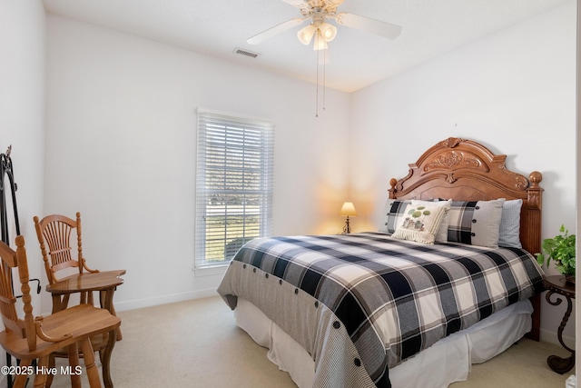 carpeted bedroom featuring baseboards, visible vents, and a ceiling fan