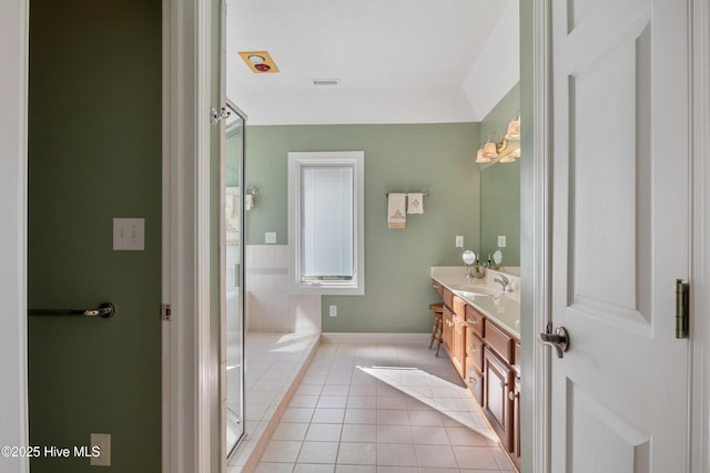 bathroom with vanity, a shower with shower door, tile patterned flooring, and visible vents