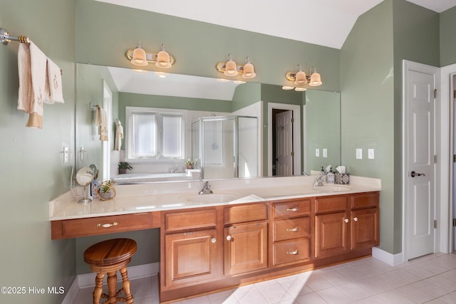 full bathroom featuring vaulted ceiling, double vanity, a stall shower, and a sink