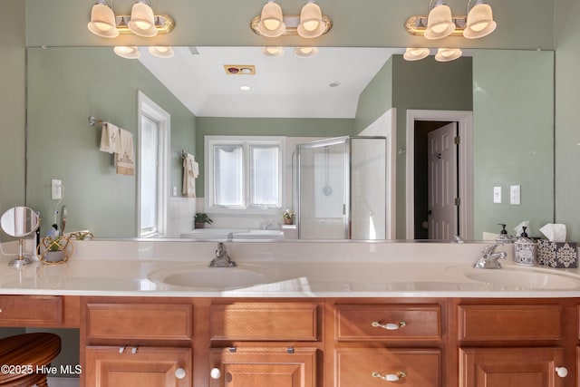 full bathroom with a bath, a stall shower, double vanity, and a sink