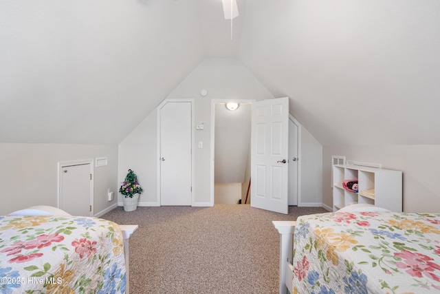 carpeted bedroom featuring ceiling fan, baseboards, and vaulted ceiling