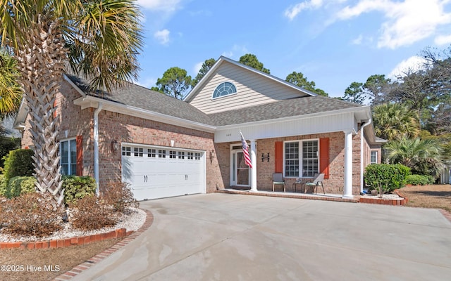 view of front of property featuring driveway, roof with shingles, a garage, and brick siding