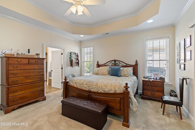 bedroom featuring recessed lighting, a tray ceiling, ornamental molding, and light colored carpet