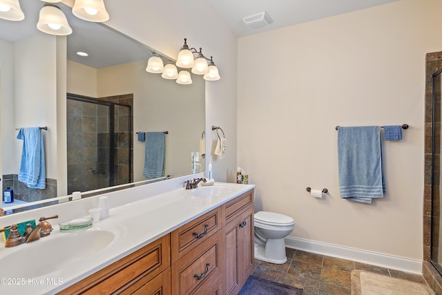 bathroom featuring baseboards, a sink, visible vents, and a shower stall