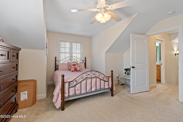 bedroom with light carpet, ceiling fan, baseboards, and vaulted ceiling