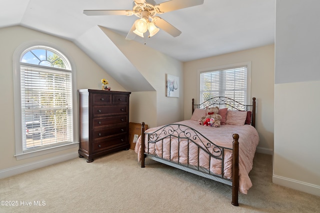 bedroom featuring vaulted ceiling, baseboards, a ceiling fan, and light colored carpet