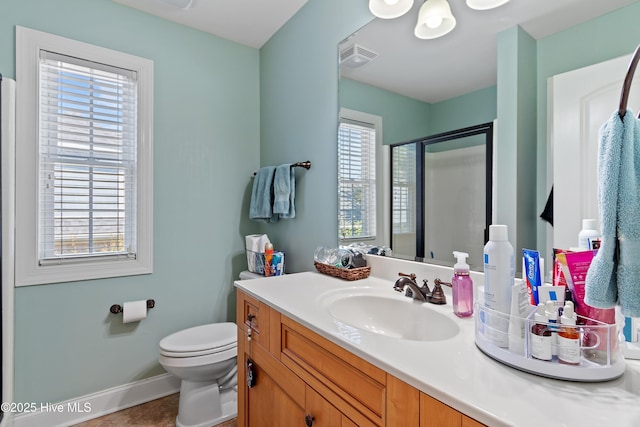 bathroom featuring a stall shower, baseboards, visible vents, toilet, and vanity