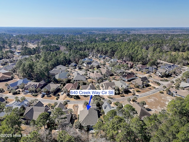 drone / aerial view with a forest view and a residential view