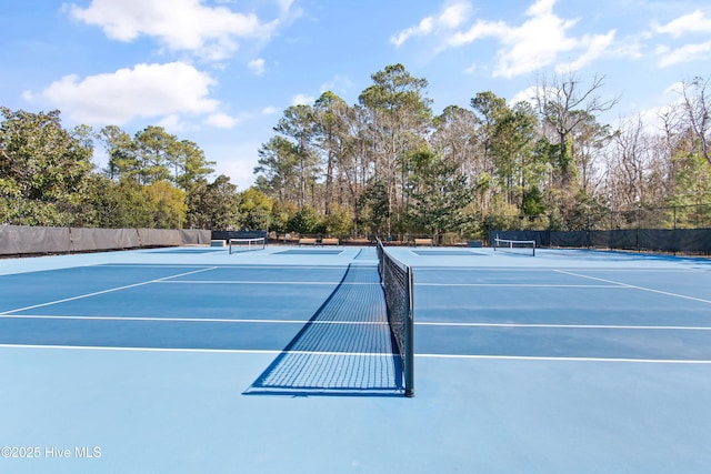 view of sport court featuring fence