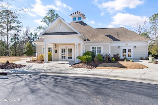 view of front of home featuring a shingled roof and french doors