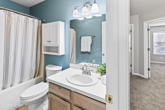 bathroom featuring shower / bath combination with curtain, vanity, toilet, and a textured ceiling