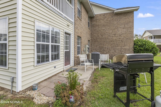 view of patio featuring cooling unit and area for grilling