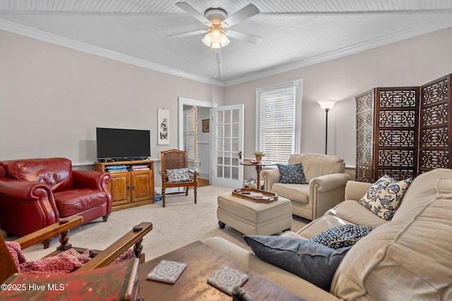 living room with light carpet, ceiling fan, and ornamental molding
