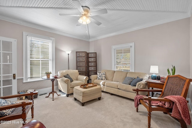 carpeted living area featuring a ceiling fan and ornamental molding