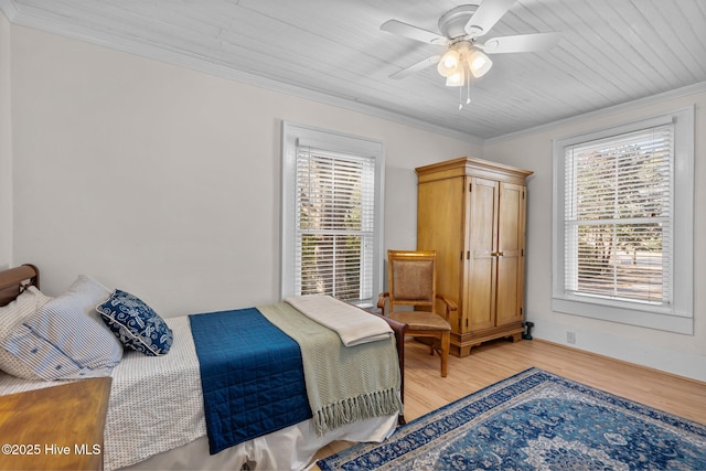 bedroom featuring light wood-type flooring, crown molding, wood ceiling, and a ceiling fan