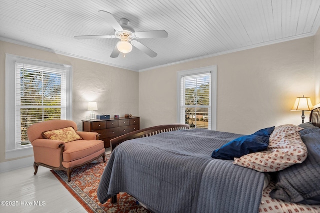 bedroom featuring light wood-style floors, ornamental molding, and a ceiling fan