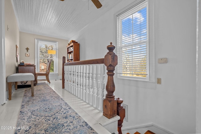 staircase featuring a ceiling fan, baseboards, and wooden ceiling