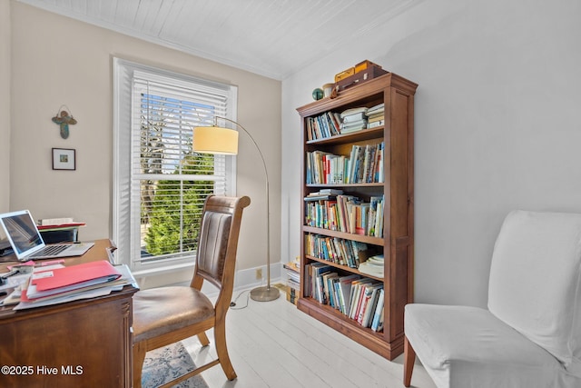 home office featuring plenty of natural light, light wood-type flooring, and crown molding