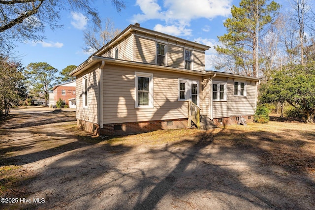rear view of property with crawl space and entry steps