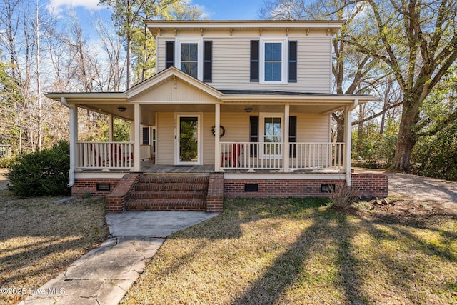 view of front of house with a porch, a front lawn, and crawl space
