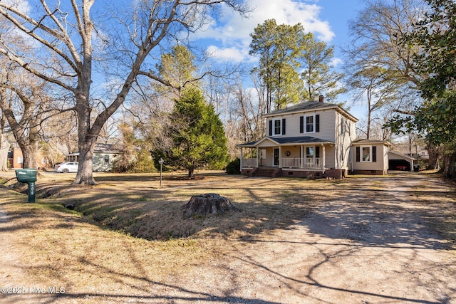 view of front of property featuring crawl space, covered porch, driveway, and a chimney