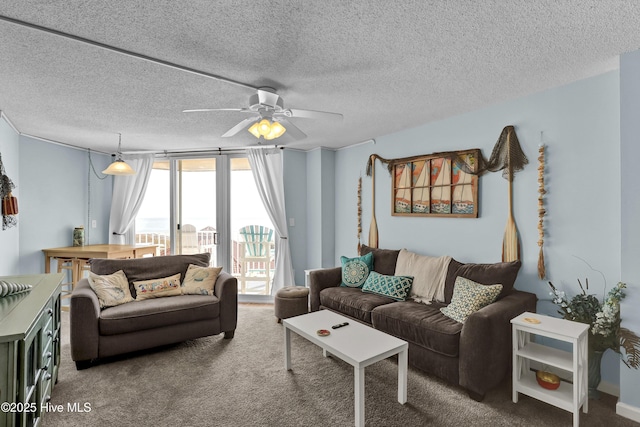 living area with ceiling fan, a textured ceiling, a city view, and carpet flooring