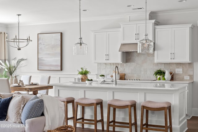 kitchen featuring visible vents, white cabinetry, light countertops, and decorative light fixtures