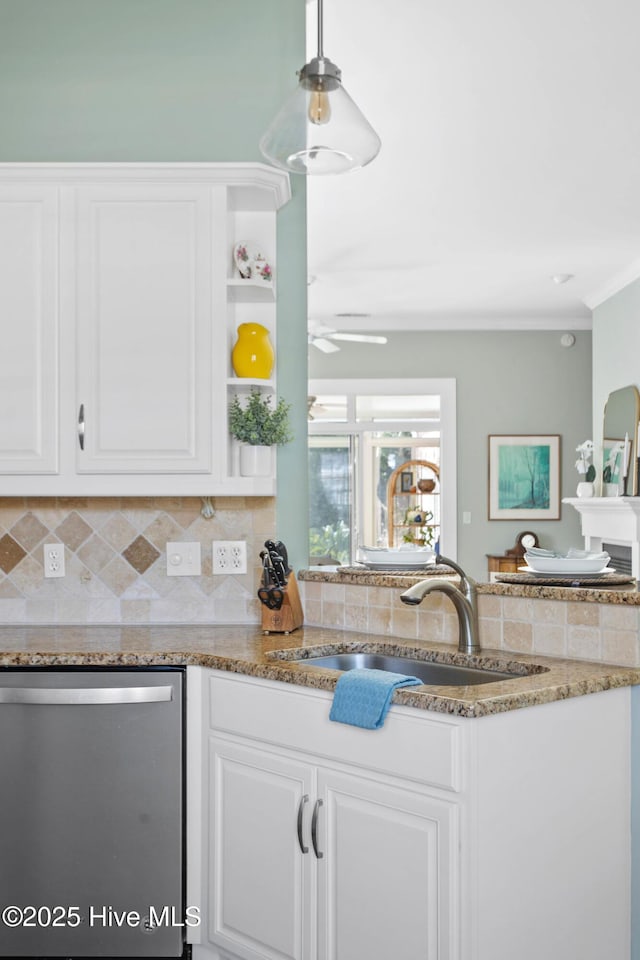 kitchen with tasteful backsplash, white cabinets, dishwasher, and a sink