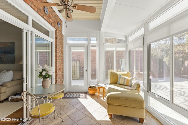 sunroom / solarium with lofted ceiling with beams and a ceiling fan