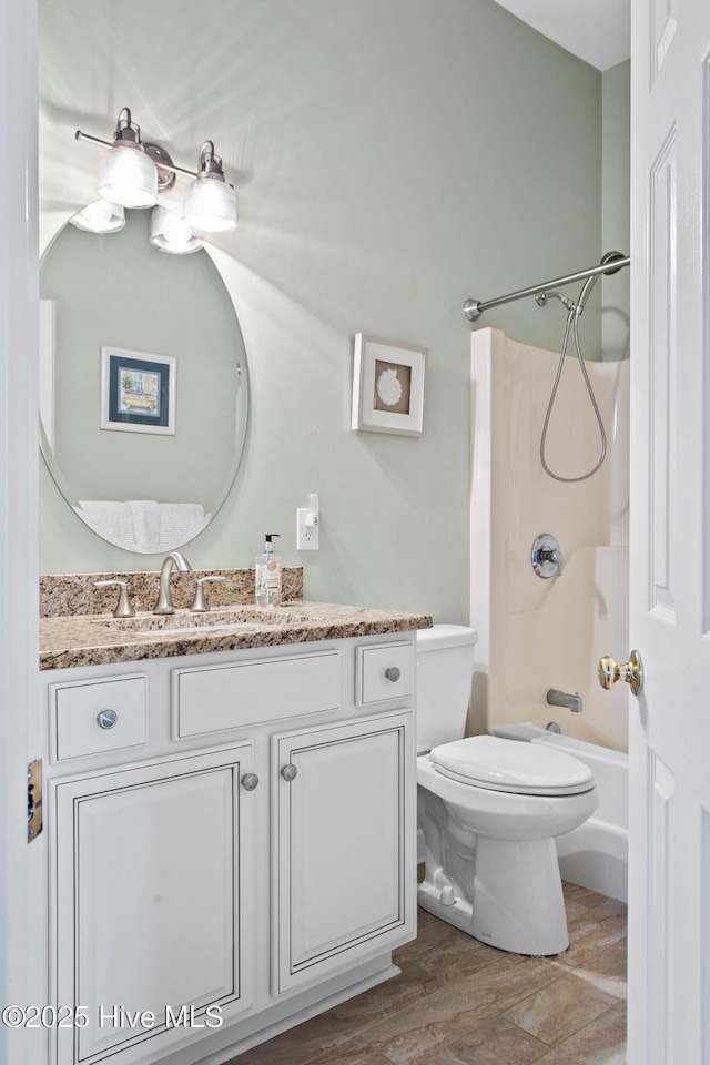 full bathroom featuring shower / washtub combination, vanity, toilet, and wood finished floors