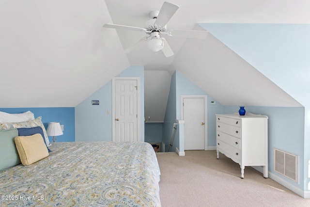 carpeted bedroom with visible vents, vaulted ceiling, and ceiling fan