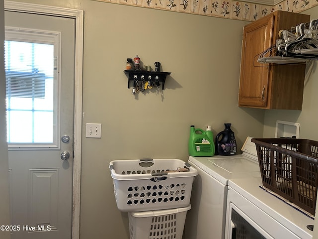 laundry area featuring cabinet space and separate washer and dryer