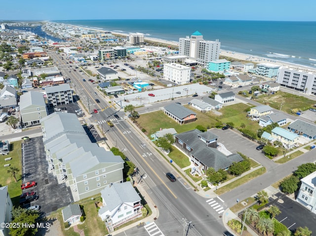 bird's eye view with a water view, a view of city, and a beach view