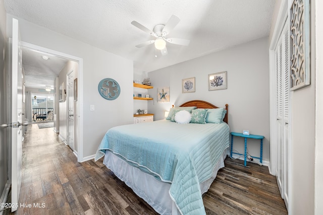 bedroom with a textured ceiling, a ceiling fan, baseboards, a closet, and dark wood finished floors