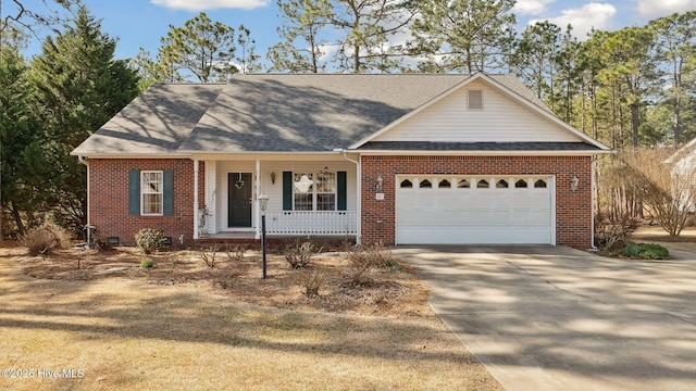 view of front of home featuring driveway, a garage, a porch, and brick siding