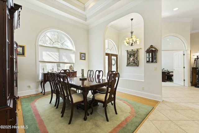 dining room with light tile patterned floors, a notable chandelier, and crown molding