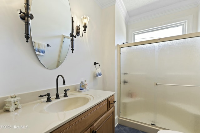 full bath with ornamental molding, a stall shower, and vanity