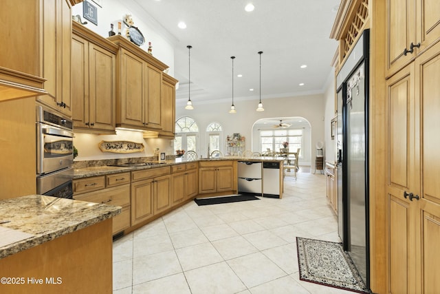 kitchen with arched walkways, light stone counters, ornamental molding, a peninsula, and built in fridge