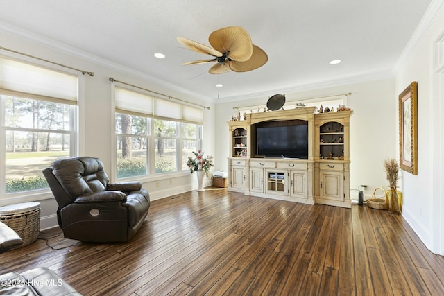 living room with dark wood-style flooring, crown molding, and baseboards