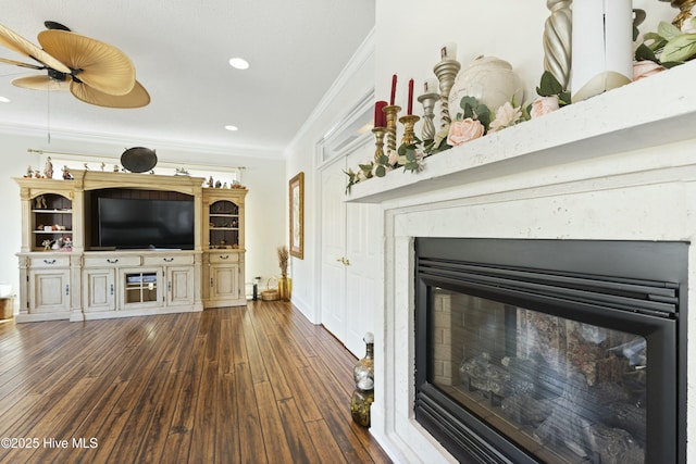 unfurnished living room with ornamental molding, a high end fireplace, recessed lighting, and dark wood-style floors