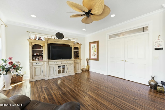 living room with dark wood-style floors, baseboards, and ornamental molding