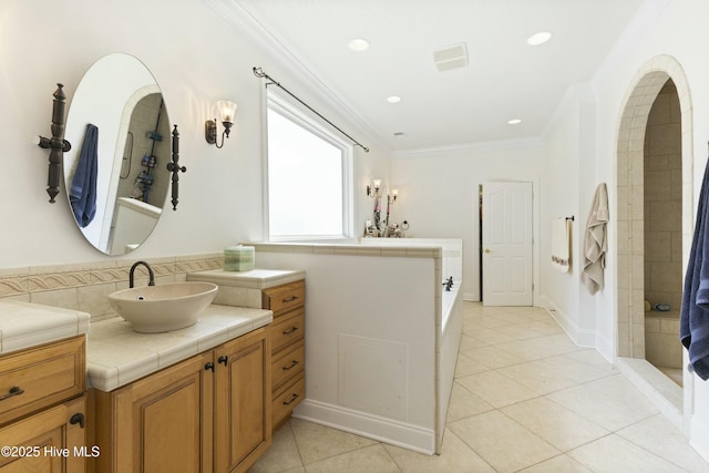 bathroom featuring tile patterned flooring, recessed lighting, vanity, ornamental molding, and tiled shower