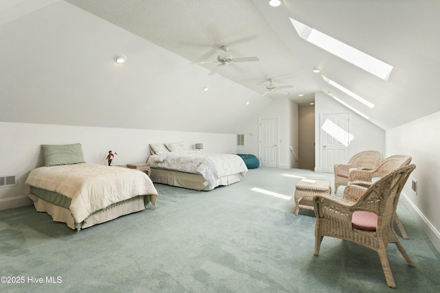 carpeted bedroom featuring lofted ceiling with skylight, visible vents, ceiling fan, and baseboards