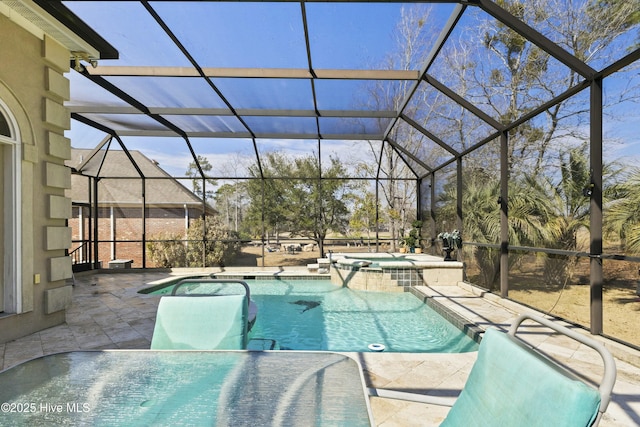 view of swimming pool with a patio area, a pool with connected hot tub, glass enclosure, and outdoor dining space