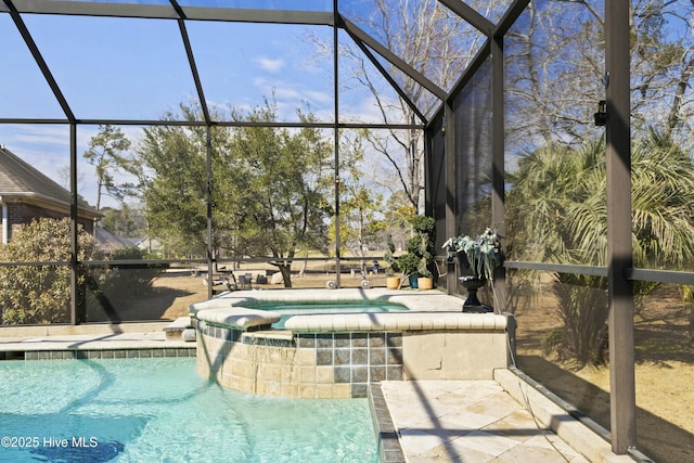 view of swimming pool with glass enclosure, a patio area, and a pool with connected hot tub