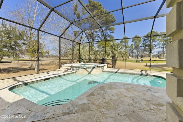 view of swimming pool featuring a pool with connected hot tub, glass enclosure, and a patio