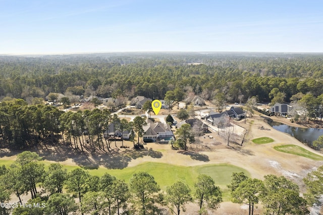 bird's eye view with golf course view and a wooded view